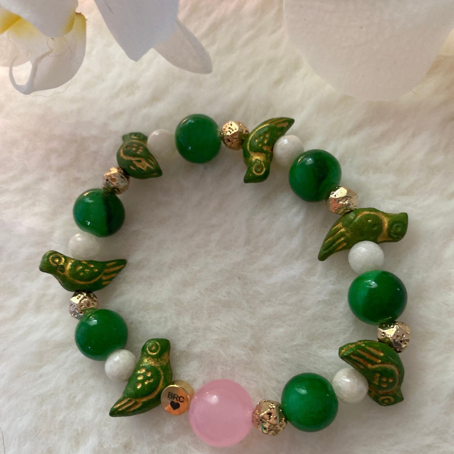 Jade Green Beaded Bracelet: Ceramic Parrot Charms, 10mm Pink Center Glass Bead.