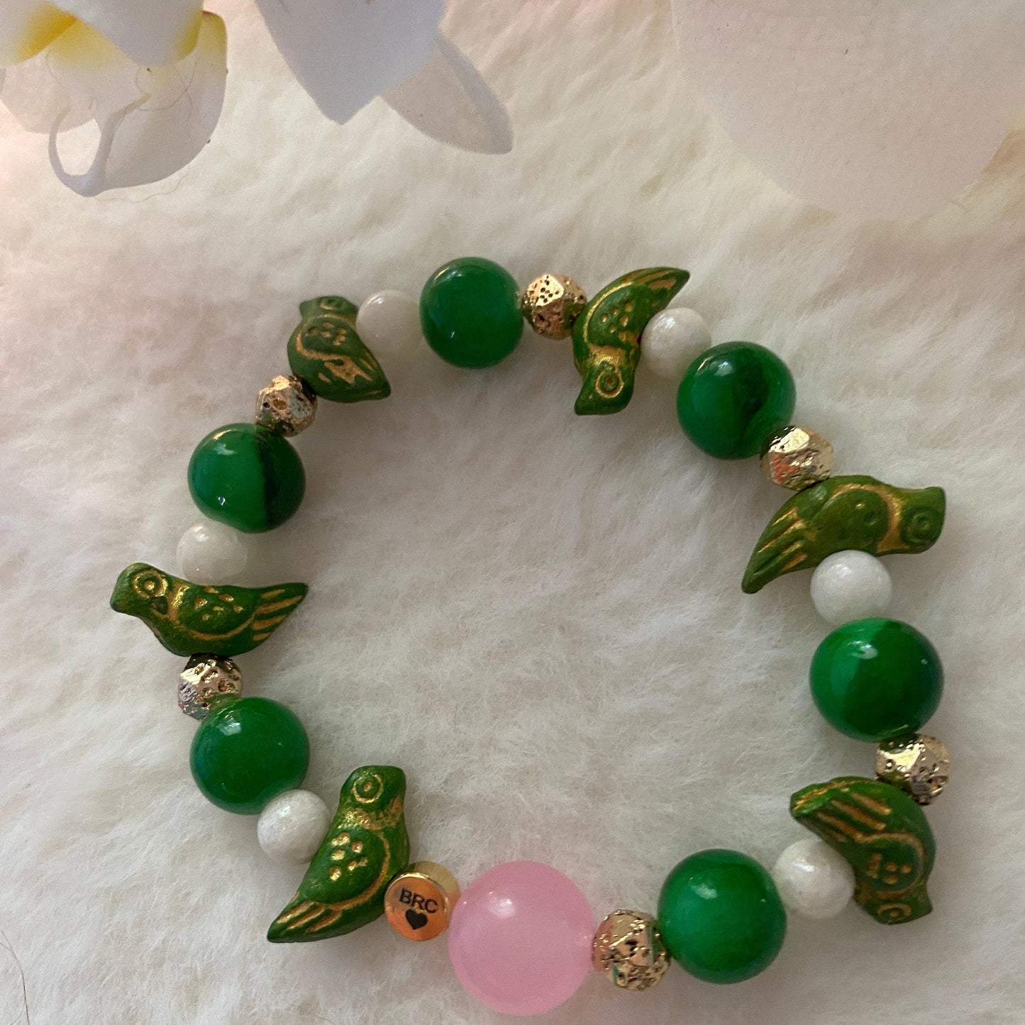 Jade Green Beaded Bracelet: Ceramic Parrot Charms, 10mm Pink Center Glass Bead.