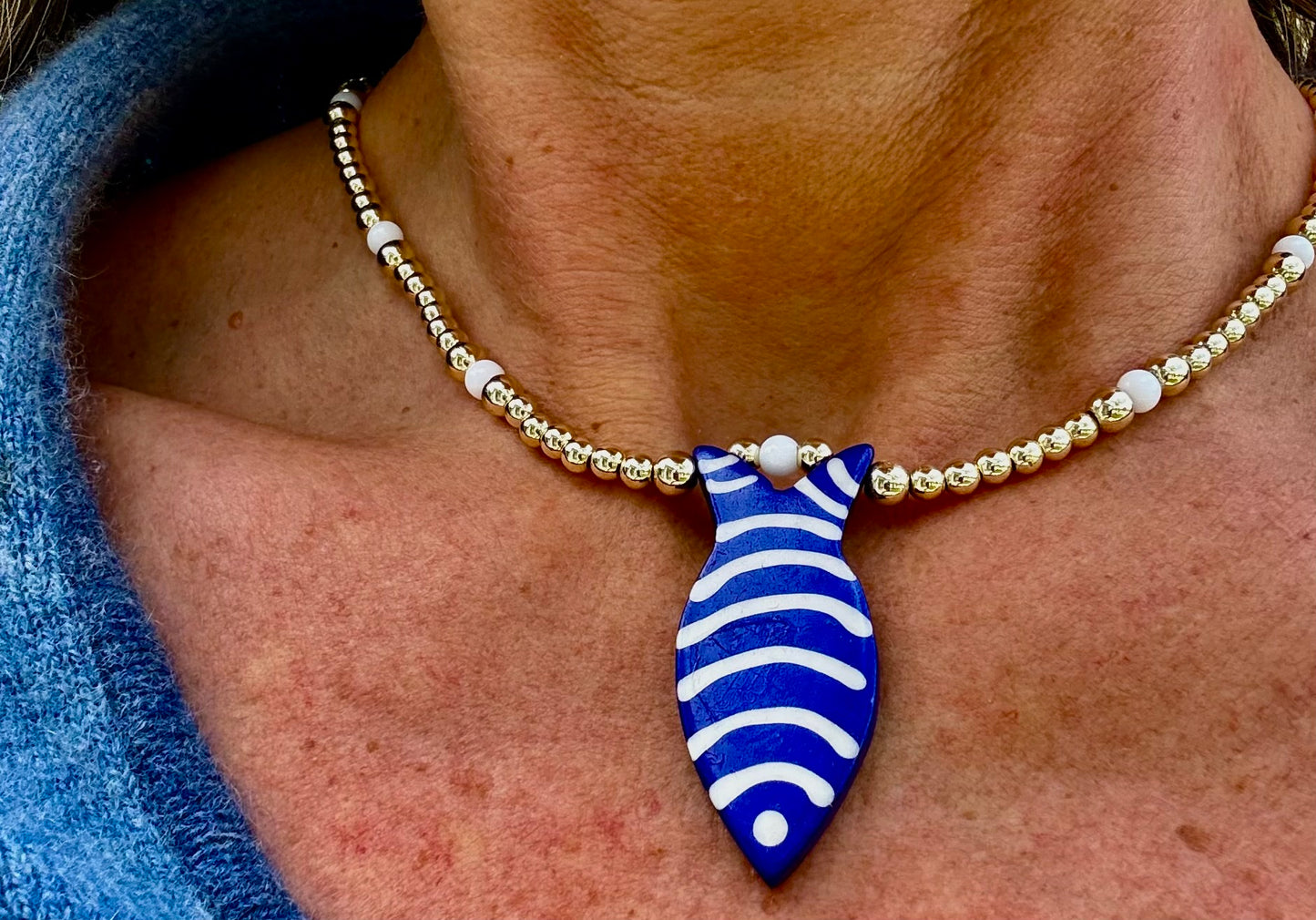Golden Blue Fish Charm Necklace. 14K Gold Beads & White Glass accents.