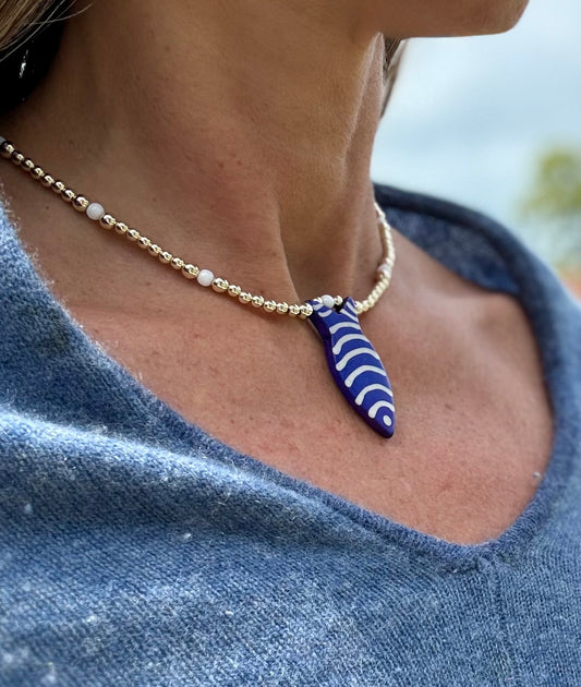 Golden Blue Fish Charm Necklace. 14K Gold Beads & White Glass accents.