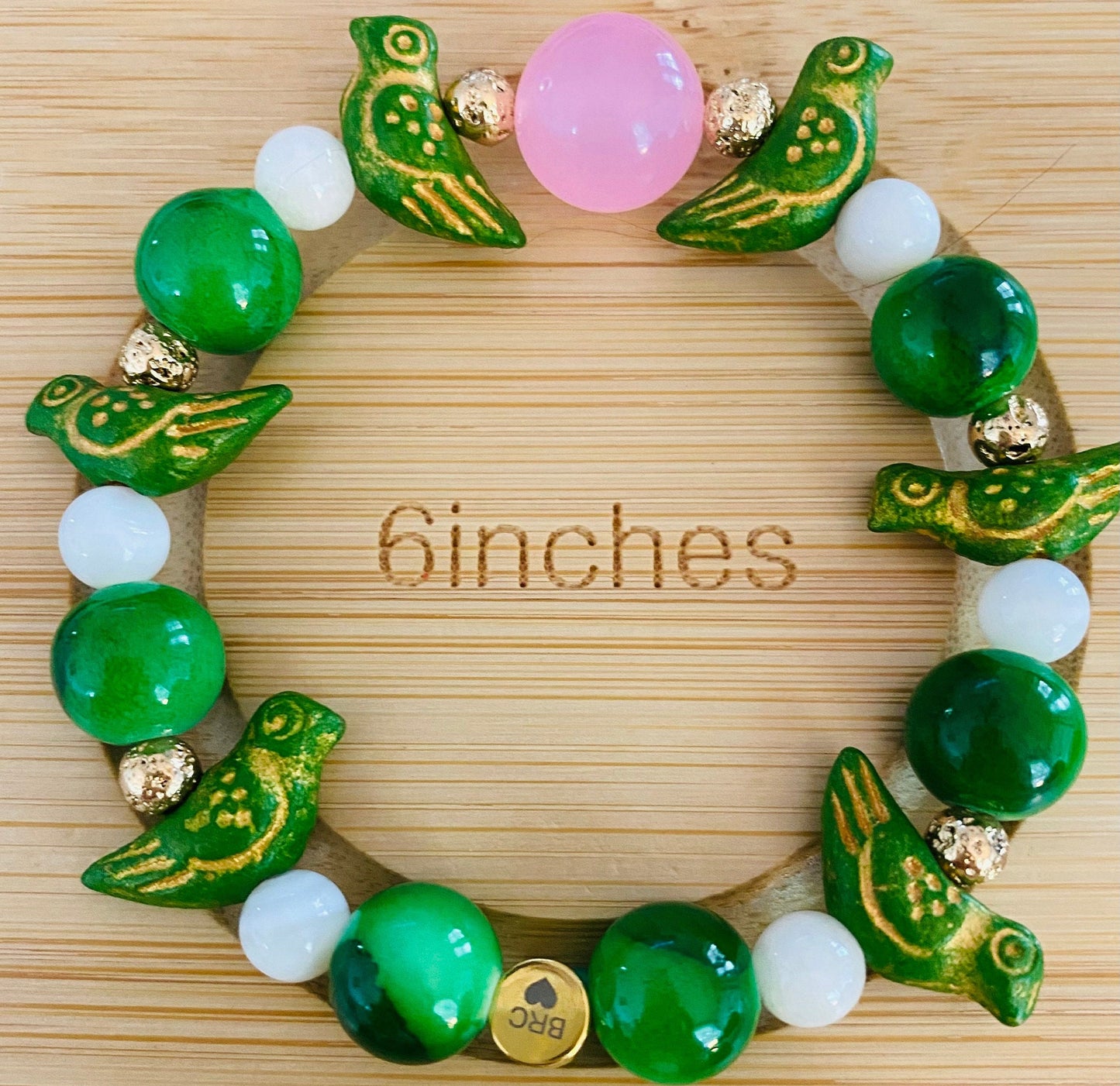 Jade Green Beaded Bracelet: Ceramic Parrot Charms, 10mm Pink Center Glass Bead.