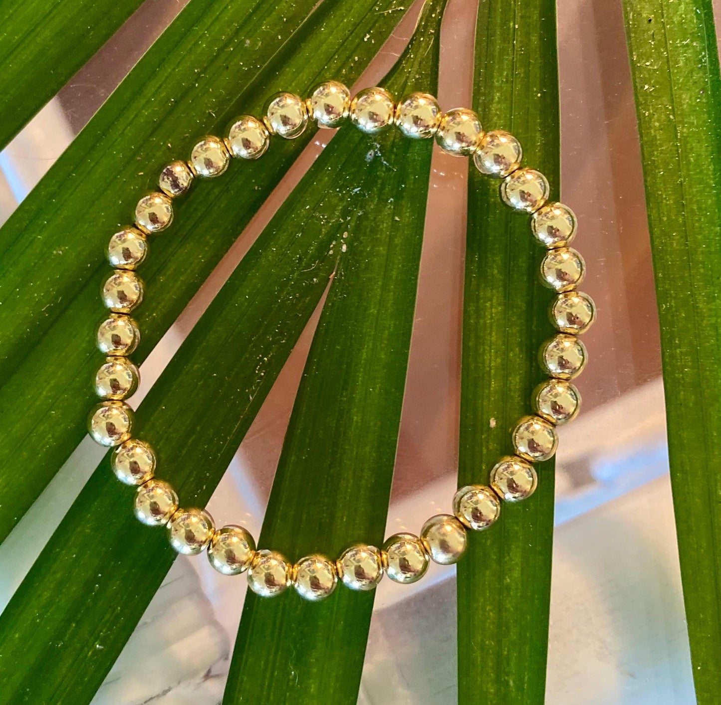 14k Gold Filled Beaded Bracelet: Center Mother of Pearl Cross, Rice Pearl, Clover Charm.
